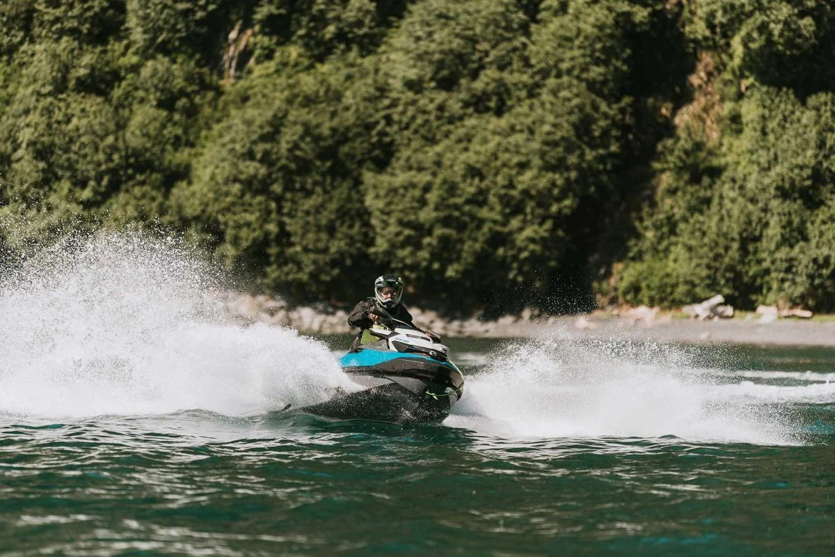 Jet ski speeding past cliff