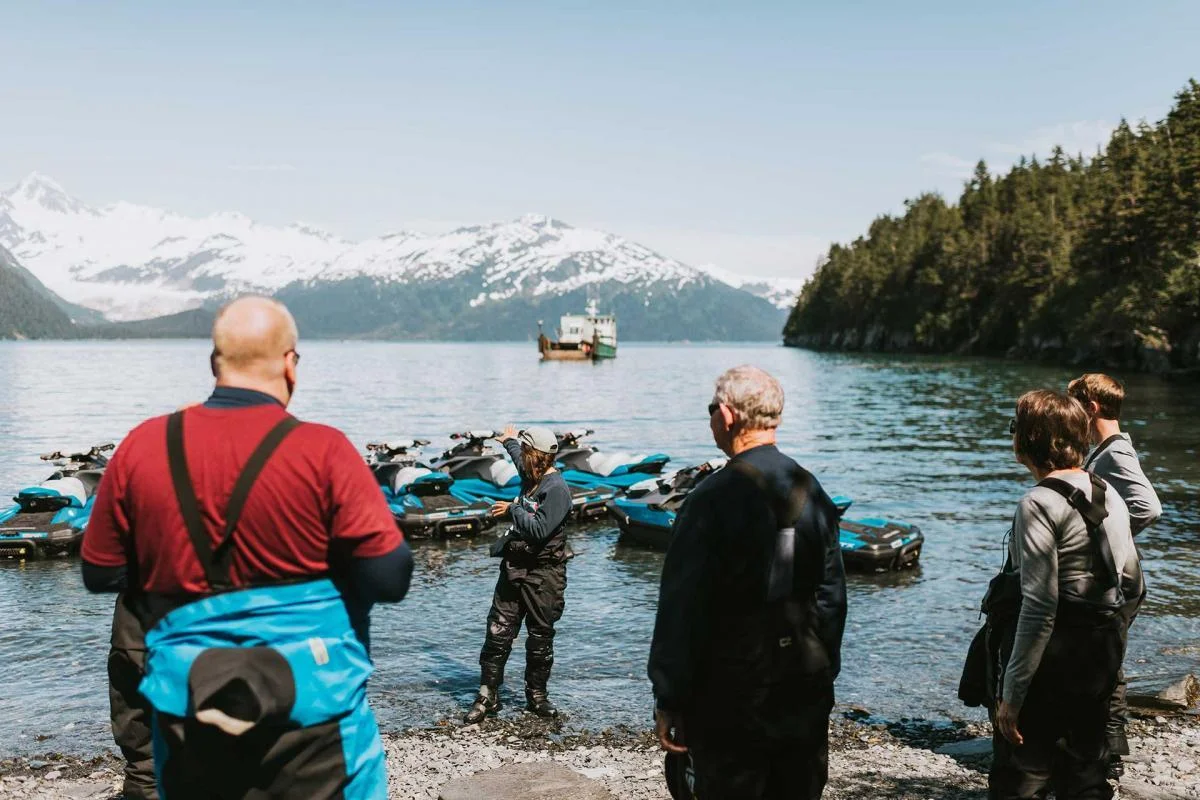 Line of jet skis with mountain backdrop